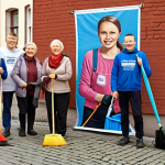 **

> Neighborhood cleanup in Poland, smiling people, community spirit, focus on "Akcja Sprzątania" banner.

**
