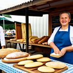 A professional, friendly Polish woman in her late 40s, wearing modest, traditional-inspired clothing and a clean apron, fully clothed, appropriate attire. She is standing behind a rustic wooden stall at a bustling outdoor farmers' market in Poland, carefully arranging freshly baked *cebularze* (traditional Polish flatbreads with onion and poppy seeds) and various artisan breads. The market is vibrant with natural sunlight, showcasing an abundance of local produce, handmade cheeses, and honey jars in the background, all in a family-friendly, appropriate setting. Professional photography, soft natural lighting, shallow depth of field, realistic, high detail, warm colors, perfect anatomy, correct proportions, natural pose, well-formed hands, proper finger count, natural body proportions, safe for work, appropriate content, fully clothed, modest.